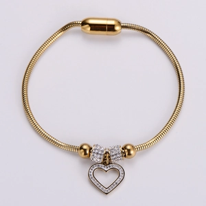 Golden snake chain bracelet featuring a magnetic clasp and a zircon-encrusted heart pendant