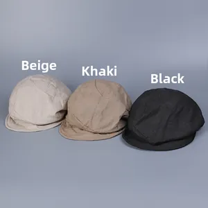 Close-up of linen flat caps in beige, khaki, and black showing breathable fabric texture