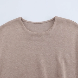 Close-up of the round neckline and soft knitted fabric texture of the khaki t-shirt