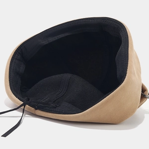 Khaki docker cap with bear ear detail, featuring inner adjustable drawstring and metal ring