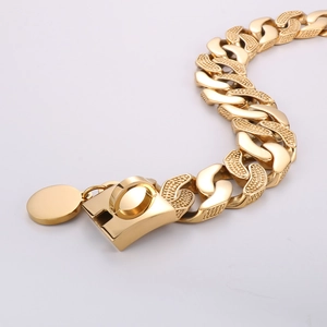 Macro view of 30mm gold Cuban link dog collar with buckle and engravable tag