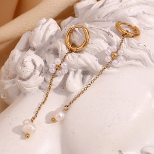 Detailed close-up of 18K gold-plated mini hoop earrings with pearl flower chain dangles