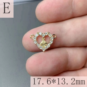 Detailed macro view of gold heart Virgin Mary pendant with cubic zirconia inlay 17.6mm