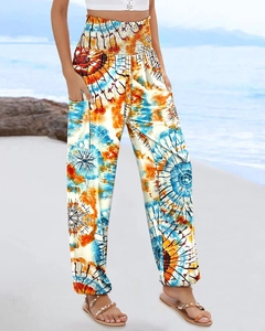 Detail of high waisted bohemian print trousers featuring side pockets and elastic ankle cuffs