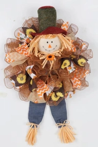 Detail of Thanksgiving scarecrow wreath with sunflower ribbons and raffia texture