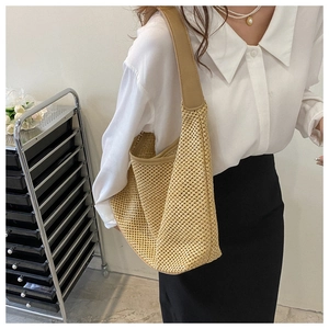 Khaki woven hobo shoulder bag with hollow mesh texture shown on a female model