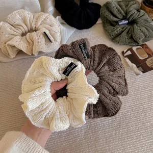Knitted ruffled hair scrunchies in earth tones with vintage crochet texture and label