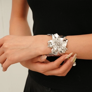 Chic silver metallic flower open bangle with detailed leaf texture for a modern statement