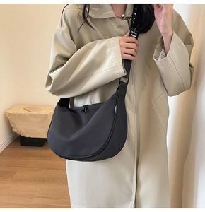 Black nylon crescent bag detail featuring stylish black and white letter pattern strap
