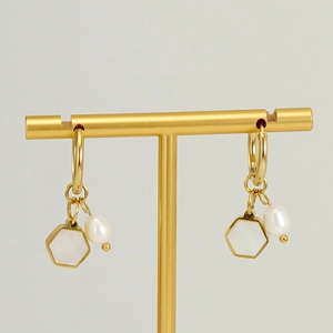 Golden earrings with hexagonal mother-of-pearl and pearl pendants on a white background