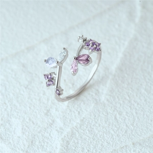 Close-up of S925 silver ring featuring purple stones and butterfly floral design