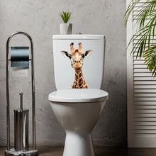 Close-up of funny giraffe sticker on white toilet tank in modern bathroom decor