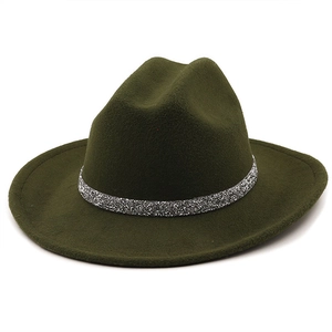 Detail of dark green wool fedora hat featuring a sparkling silver glitter decorative band