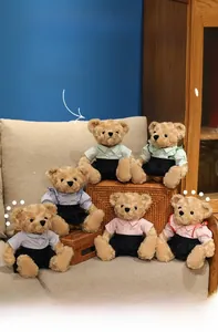 Detail of assorted teddy bears in preppy outfits sitting on a sofa and basket