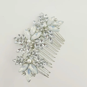 Detail of bridal hair comb with silver metal base, clear rhinestones and white pearls