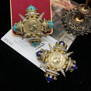 Detail of vintage gold brooches with lapis and turquoise featuring Napoleon Emperor coins