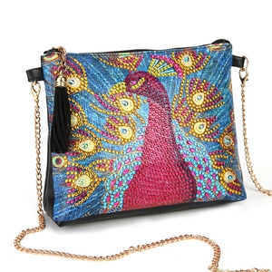Detail of DIY diamond painting peacock cross-body bag with gold chain and black tassel