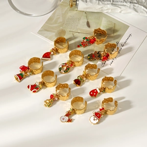 Macro detail of 12pcs gold Christmas charms rings set with festive colorful enamel pendants