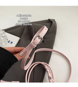 Close-up of pink leather strap with adjustable silver buckle and fine stitching