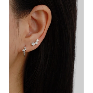 Close-up of s925 silver geometric hoop earrings and ear cuff with clear zircon stones