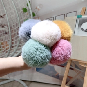 Close-up of soft faux fur hair ties in grey, white, yellow, green, and pink colors