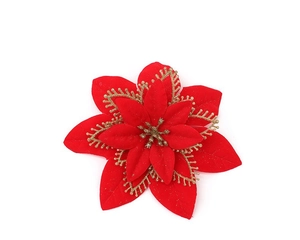 Detailed view of red artificial Christmas flower with gold glitter petals on white background