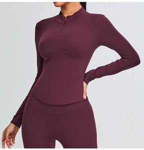 Slim fit burgundy half-zip yoga top and flared leggings set showing fabric texture