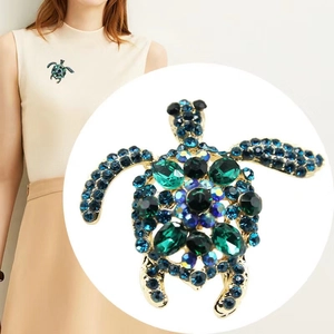 Exquisite gold-plated turtle brooch with emerald green crystals and blue rhinestones