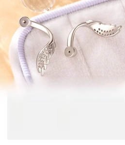 Macro shot of silver wing earrings inlaid with zircons and product specifications
