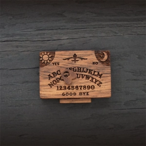Detailed engraving of the sun and moon on a miniature wooden Ouija board box