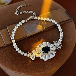 Details des silbernen Blumenarmbands mit schwarzem Edelstein und weißen Zirkonia-Kristallen