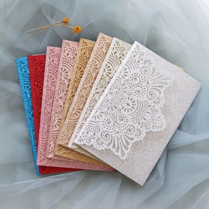 Detailed laser-cut hollow gift boxes in shimmering gold and silver for wedding favors