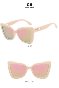 Detail view of cat-eye sunglasses featuring chain-link temples and peach gradient lenses