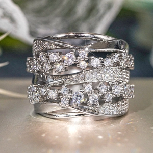 Macro shot of wide multi-layer silver ring with micro-paved sparkling cubic zirconia stones