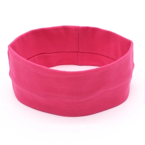 Detailed close-up of rose red knitted elastic yoga headband with soft cotton texture