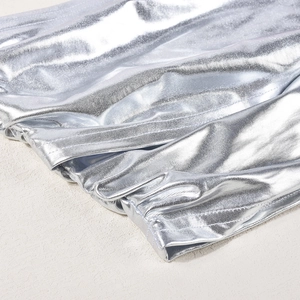Detail of silver metallic reflective fabric showing precision double stitching on the hem