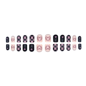 Pink and black heart press-on nails set with checkered patterns on white background