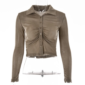 Detail of a brown mesh long sleeve cropped shirt with button-front and ruched textures