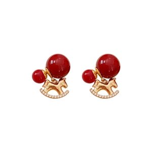 Gold plated rocking horse earrings with red beads and sparkling zircon accents