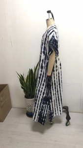 Detail of V-neck beach kaftan with black and white tie-dye pattern and side slits