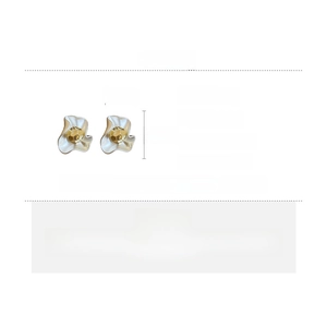 Detail view of wavy flower earrings with white glaze and gold core, 2.5cm size