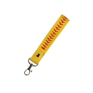 Detail of yellow leather baseball keychain showing red stitching and metal ring