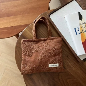 Vintage camel suede handheld bag with paisley floral embroidery and woven label