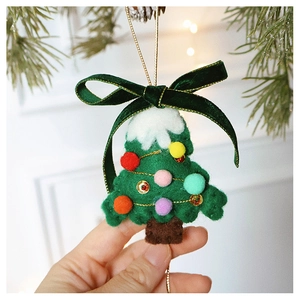 Detail of handmade wool felt Christmas tree hanging ornament with velvet bow and gold sequins