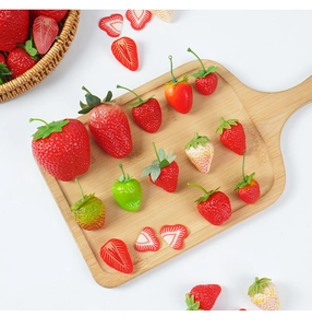 Detailed macro view of artificial strawberries with sliced and whole fruit prop textures
