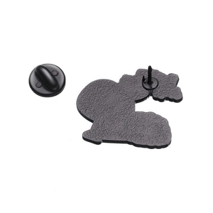 Detail view of the matte metal back of the pin with a black rubber clutch fastener