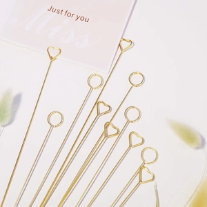 Golden heart and round metal floral card holders arranged for flower arrangements
