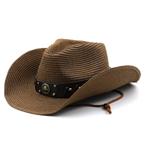 Macro view of dark brown straw cowboy hat featuring metal studs and horseshoe buckle detail