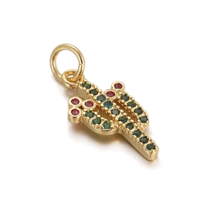 Detail of 18K gold cactus pendant with green and red zircons on white background