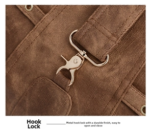 Close-up of golden metal hook clasp and twill fabric texture on large tote bag